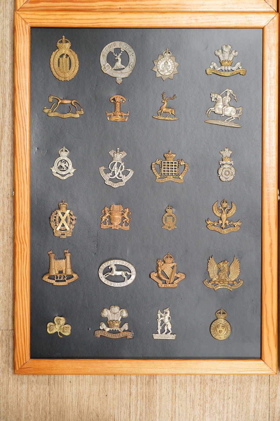 A collection of ninety-seven military cap badges mounted on four boards including; The City of London Yeomanry, Duke of Lancaster‘s Own, Bedfordshire Regiment, Leicestershire Regiment, Seventh Battalion Hampshire Regimen